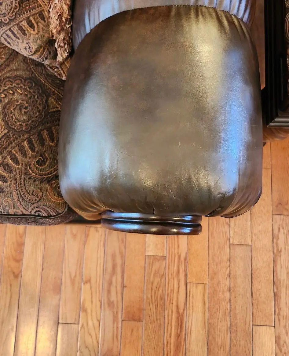 The same recliner corner restored to a smooth, deep brown finish